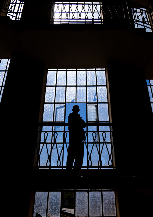 Silhouette of a man standing in the stairs in an old italian building, Central Region, Asmara, Eritrea