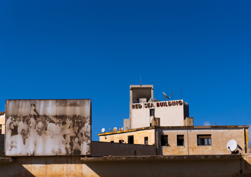 Red sea building near a Isaias Afwerki propaganda billboard, Central Region, Asmara, Eritrea