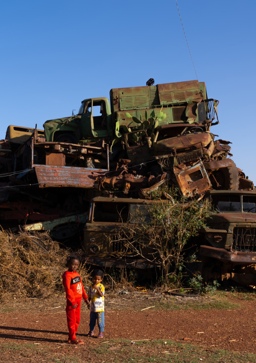 Eritrean children in the military tank graveyard, Central Region, Asmara, Eritrea