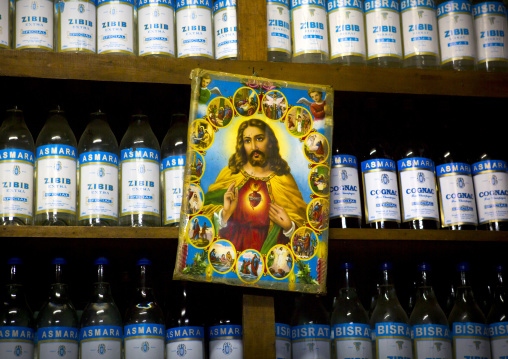 Jesus poster in front of zibib and cognac bottles, Central Region, Asmara, Eritrea