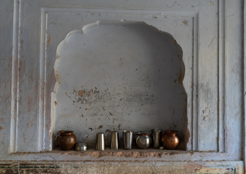 Steel cups in a niche inside Galtaji temple, Rajasthan, Jaipur, India