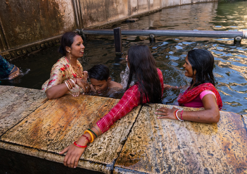Indian pilgrims having a bath in Galtaji temple aka monkey temple, Rajasthan, Jaipur, India
