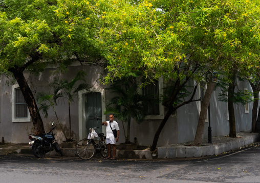 Indian man with bicycle in the french quarter, Pondicherry, Puducherry, India