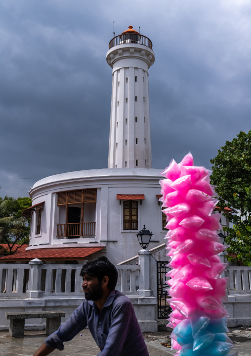 Indian man on a bicycle passing in front of the new lighthouse, Pondicherry, Puducherry, India