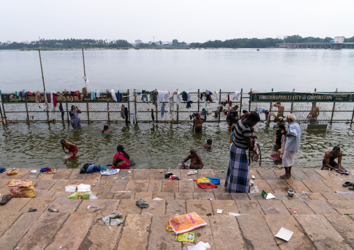 Indian people bathing in holy river, Tamil Nadu, Tiruchirappalli, India