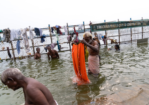 Indian people bathing in holy river, Tamil Nadu, Tiruchirappalli, India