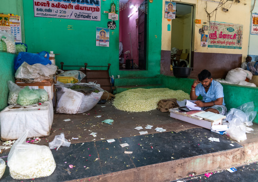Indian man selling flowers in a market, Tamil Nadu, Madurai, India