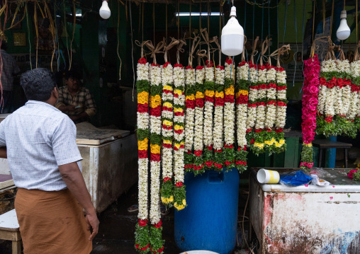 Indian man selling flowers in a market, Tamil Nadu, Madurai, India