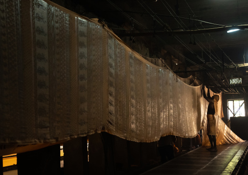 Indian worker drying textiles after manual Screen Printing, Rajasthan, Jaipur, India