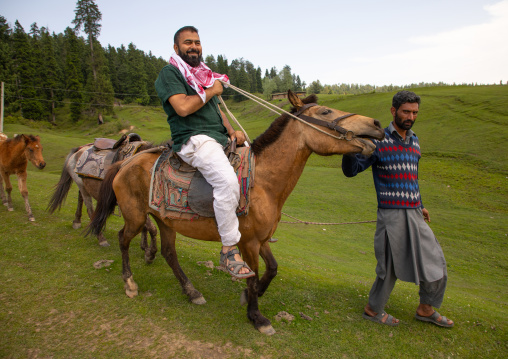Indian tourist riding a horse, Jammu and Kashmir, Yusmarg, India