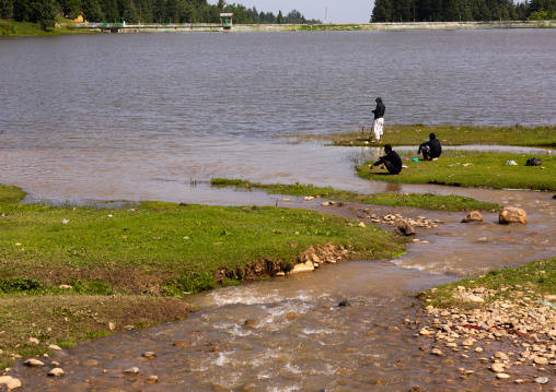 Indian men fishing in a lake, Jammu and Kashmir, Yusmarg, India
