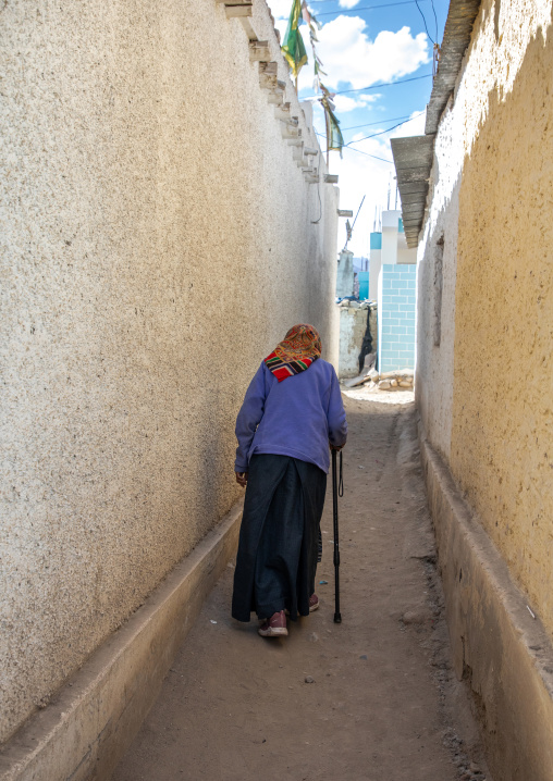 Old woman in Sonamling Tibetan settlement street, Ladakh, Leh, India
