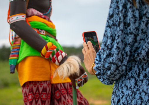 Western tourist taking picture of a samburu morane, Samburu County, Samburu National Reserve, Kenya