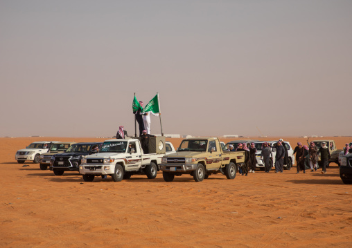 Saudi men following camels with their cars during King Abdul Aziz Camel Festival, Riyadh Province, Rimah, Saudi Arabia