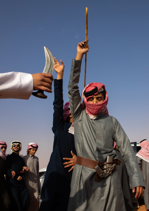 Saudi men dancing during King Abdul Aziz Camel Festival, Riyadh Province, Rimah, Saudi Arabia