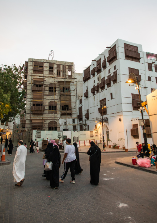 Tourists in front of old houses with wooden mashrabiya in al-Balad quarter, Mecca province, Jeddah, Saudi Arabia