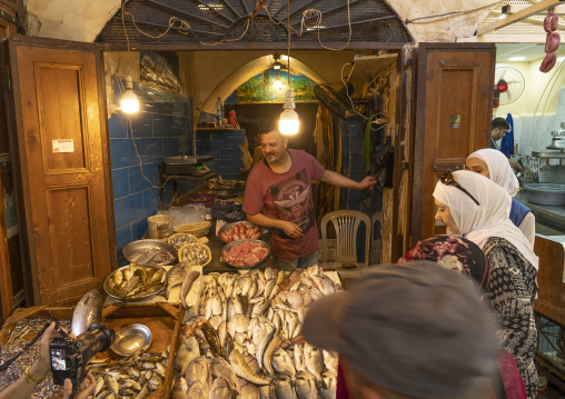 Women buying fishes in Fish market in the old souk, North Governorate, Tripoli, Lebanon
