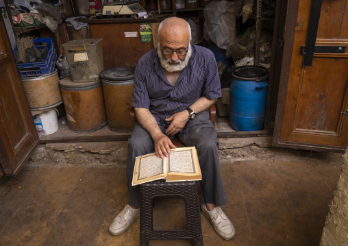 Muslim man reading the quran in the old souk, North Governorate, Tripoli, Lebanon