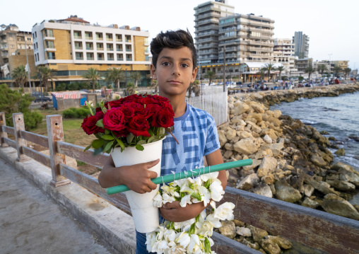 Young syrian boy selling flowers on the corniche, North Governorate, Tripoli, Lebanon