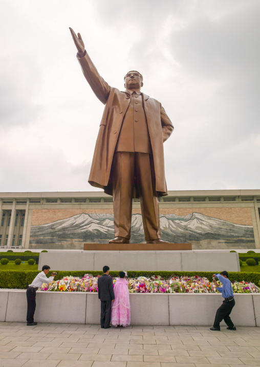 Couples celebrating their weddings in front of Kim il Sung statue in Mansudae, DGC, Pyongyang, North Korea