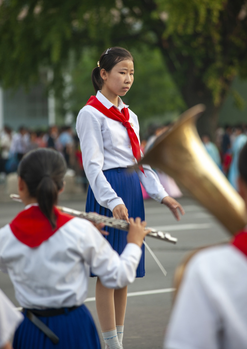 Pioneers playing music in the street during a celebration, DGC, Pyongyang, North Korea