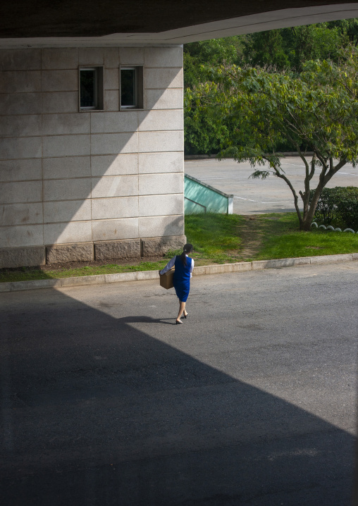 North Korean woman crossing an empty highway, DGC, Pyongyang, North Korea