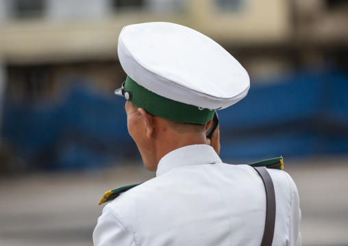 North Korean male traffic security officer speaking on mobile phone, North Hwanghae, Kaesong, North Korea