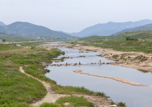 North Korean people washing clothes in a river, North Hwanghae, Kaesong, North Korea