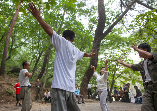 North Korean electricity company workers dancing in a park, North Hwanghae, Kaesong, North Korea