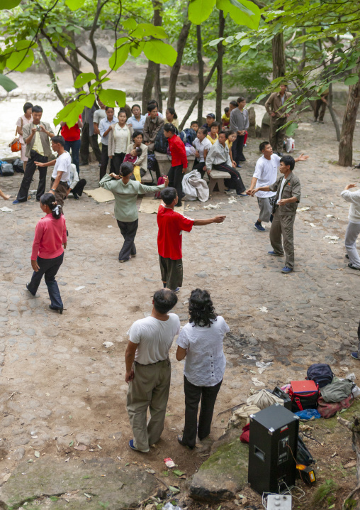 North Korean electricity company workers dancing in a park, North Hwanghae, Kaesong, North Korea