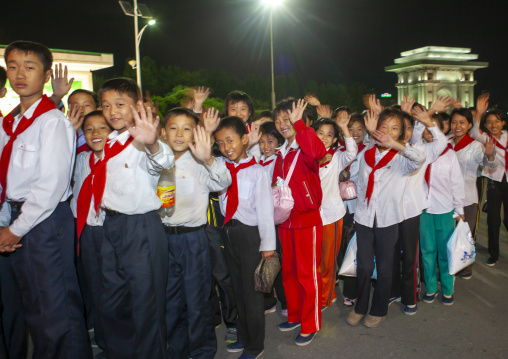 Pioneers children queueing in a fairground attraction at Kaeson youth park, DGC, Pyongyang, North Korea