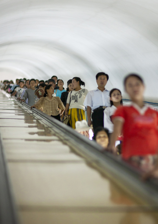 North Korean people using escalator leading to the subway station, DGC, Pyongyang, North Korea
