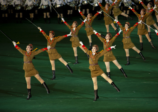 Women dressed as soldiers dancing with swords during the Arirang, DGC, Pyongyang, North Korea