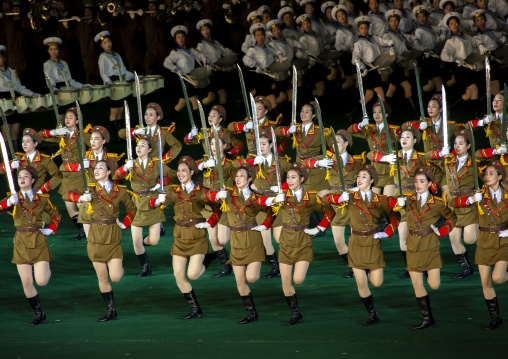 Women dressed as soldiers dancing with swords during the Arirang, DGC, Pyongyang, North Korea