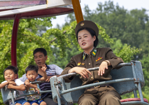 North Korean female soldier on an attraction in Taesongsan funfair, DGC, Pyongyang, North Korea