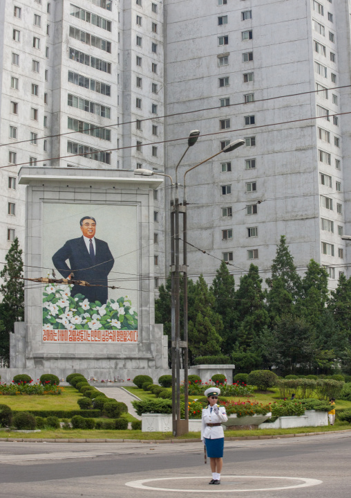 North Korean traffic security officer in front of Kim Il Sung fresco, DGC, Pyongyang, North Korea