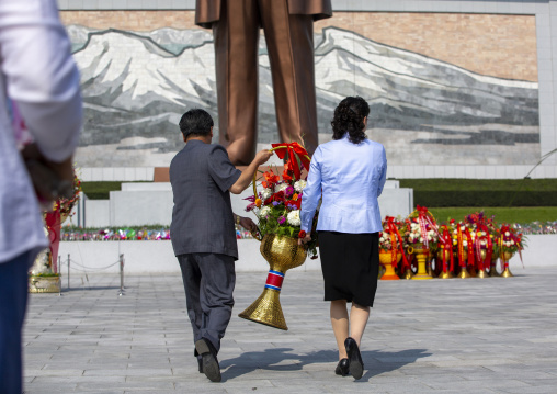 People bringing flowers to the statues of the Leaders in the Grand monument, DGC, Pyongyang, North Korea