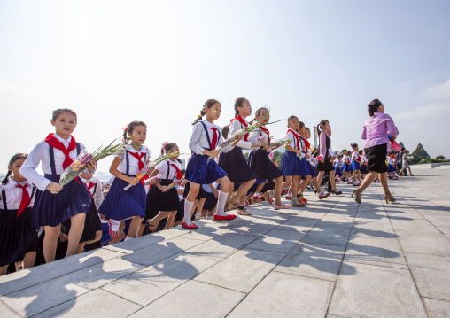 Pioneers from the Korean children's union in the Grand monument, DGC, Pyongyang, North Korea