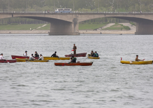 North Korean people paddling on small boats on Taedong river, DGC, Pyongyang, North Korea