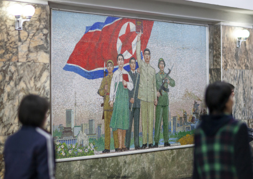 North Korean women in front of a fresco in Puhung metro station, DGC, Pyongyang, North Korea