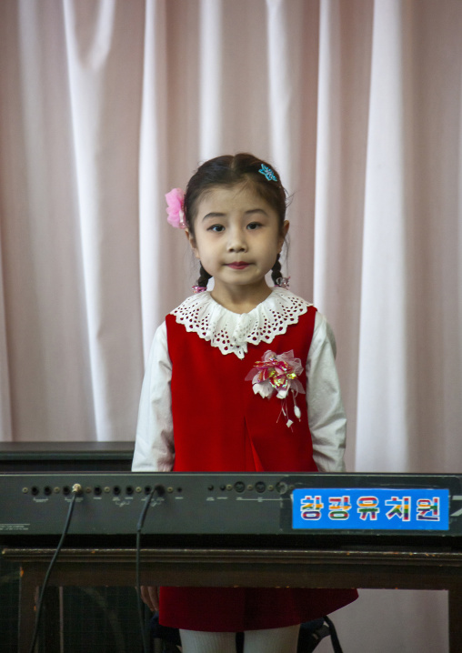 Portrait of North Korean schoolgirl with a keyboard, DGC, Pyongyang, North Korea