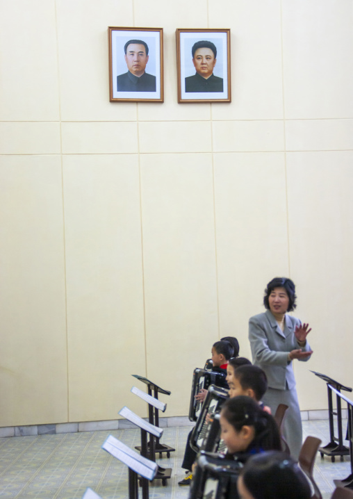 Accordion class in children's palace under the portraits of the Leaders, DGC, Pyongyang, North Korea