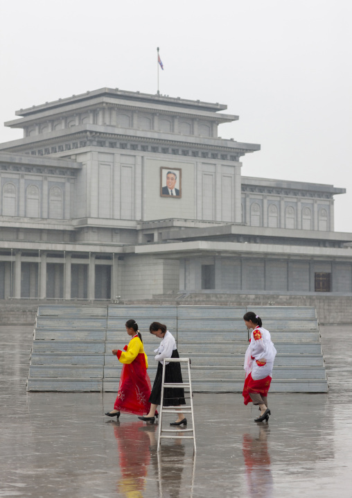 North Korean women under the rain in Kumsusan memorial palace, DGC, Pyongyang, North Korea
