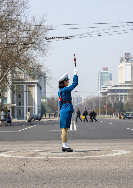 North Korean female traffic security officer in blue uniform in the street, DGC, Pyongyang, North Korea