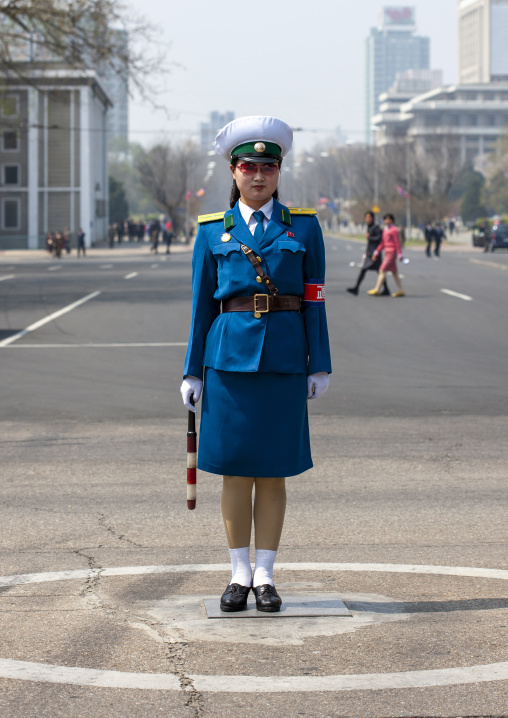 North Korean female traffic security officer in blue uniform in the street, DGC, Pyongyang, North Korea