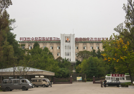 Building with Kim il Sung portrait and propaganda cars with loudspeakers, Kangwon Province, Wonsan, North Korea