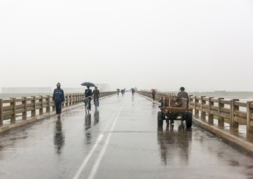 North Korean people on a rainy road, South Hamgyong, Hamhung, North Korea