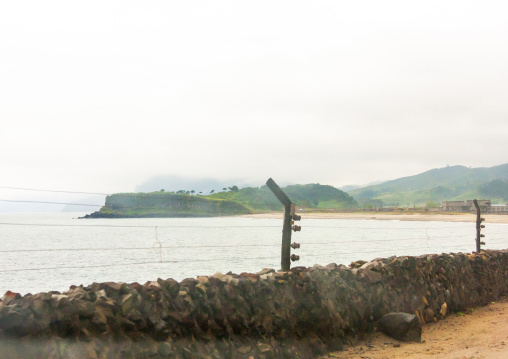 Electric fence on a road along the coast, North Hamgyong, Chilbosan, North Korea