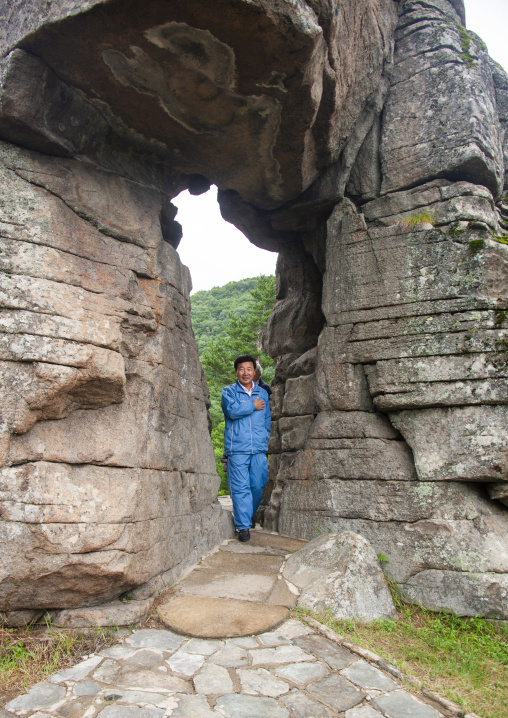 North Korean guide showing the famous wedding rock, North Hamgyong, Chilbosan, North Korea