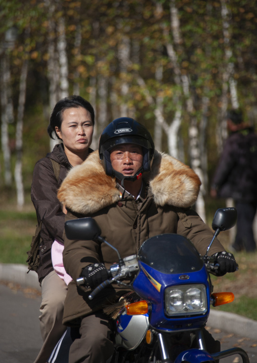 North korean couple riding a motorbike, Ryanggang, Samjiyon, North Korea
